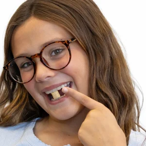child holding blossom gum